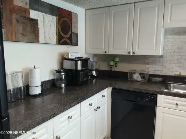 a kitchen with stainless steel appliances granite countertop a sink a stove and dishwasher