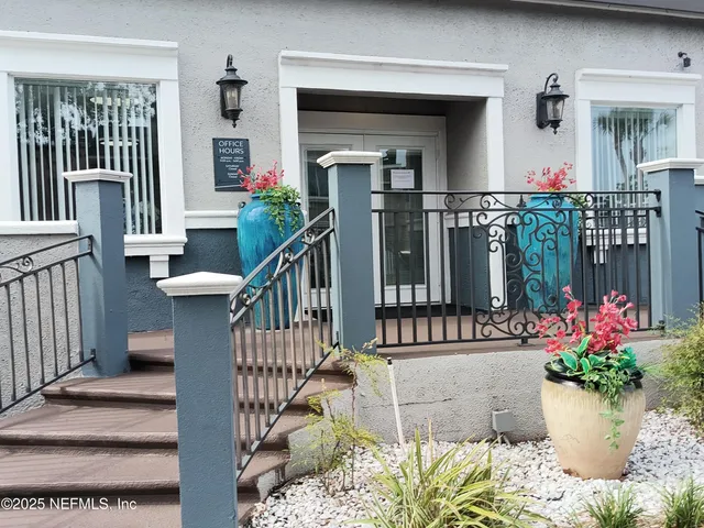 a view of a balcony with flower plants