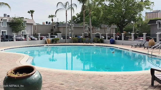a swimming pool with outdoor seating and yard