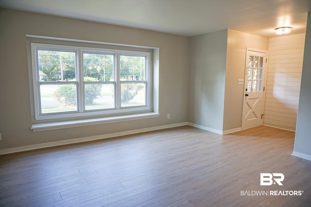 6205 Zeigler Boulevard Mobile, AL 36608 - Photo 6 of 17 Unfurnished room featuring wood finished floors and baseboards