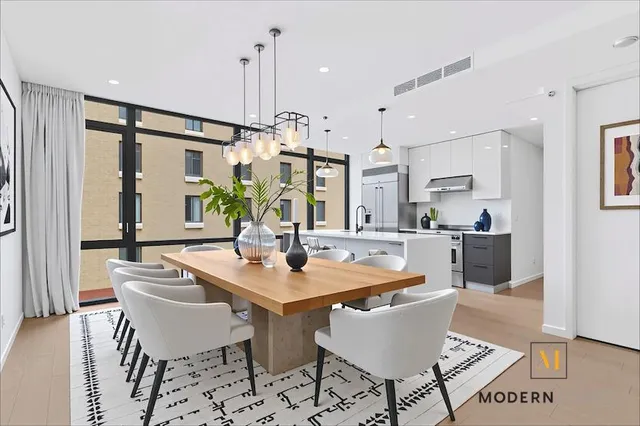 a view of a dining room with furniture and a chandelier