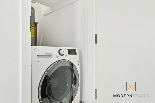 a view of a hallway with washer and dryer