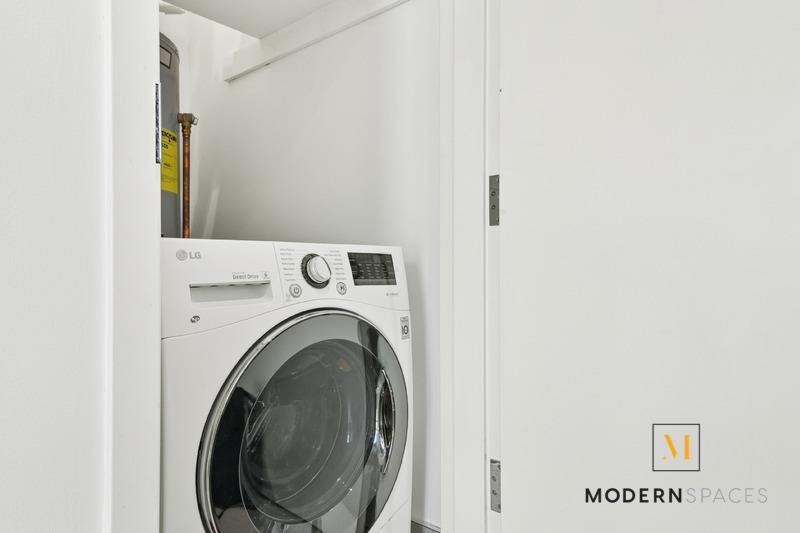 24-12 42nd Road, Unit 4A Queens, NY 11101 - Photo 11 of 17 a view of a hallway with washer and dryer