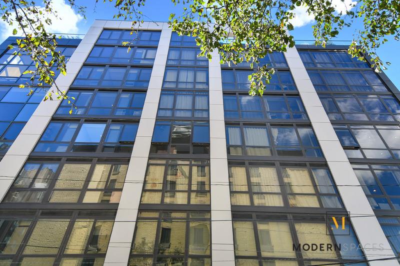 24-12 42nd Road, Unit 4A Queens, NY 11101 - Photo 13 of 17 a view of a tall brick building