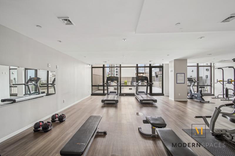 24-12 42nd Road, Unit 4A Queens, NY 11101 - Photo 15 of 17 a room with lots of furniture and wooden floor