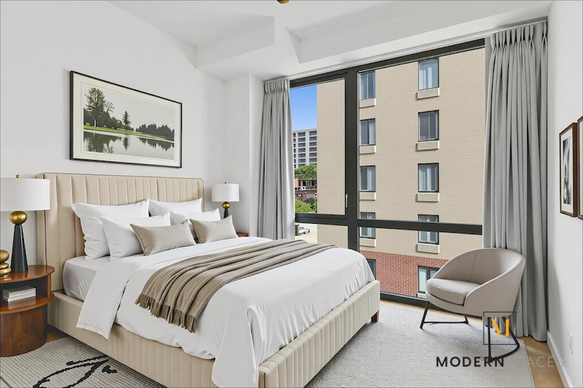 24-12 42nd Road, Unit 4A Queens, NY 11101 - Photo 6 of 17 a bedroom with a bed and a large window