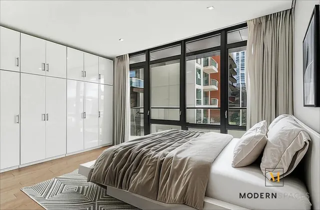 a bedroom with a bed and a window