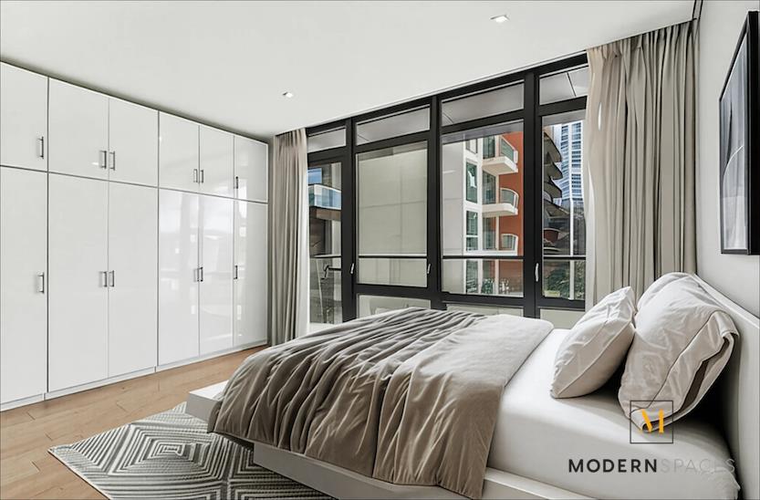 24-12 42nd Road, Unit 4A Queens, NY 11101 - Photo 8 of 17 a bedroom with a bed and a window