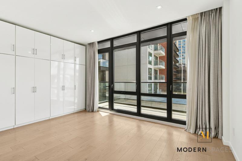 24-12 42nd Road, Unit 4A Queens, NY 11101 - Photo 9 of 17 a view of staircase with white walls