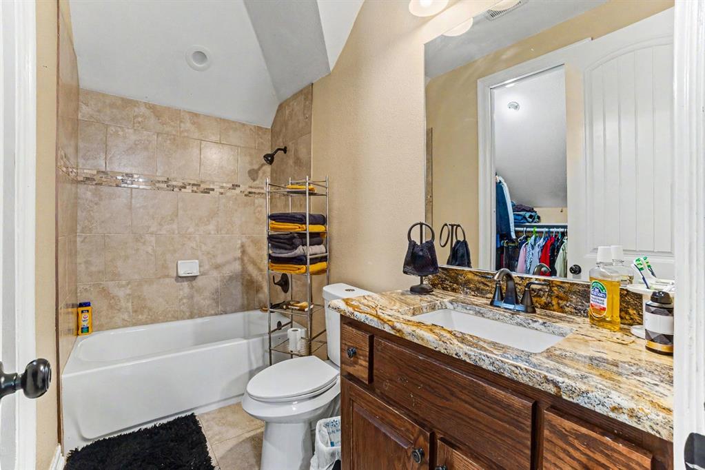505 South Bluegrove Road Lancaster, TX 75146 - Photo 20 of 37 a bathroom with a granite countertop sink toilet and shower