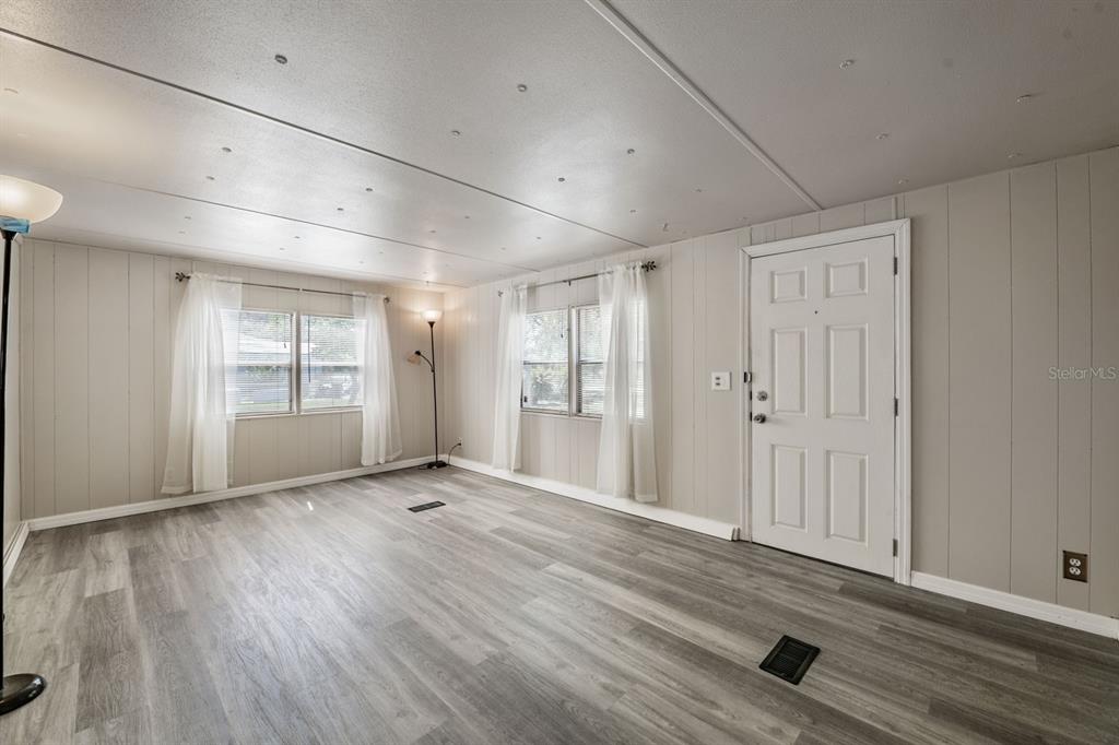 9739 Ray Street Hudson, FL 34669 - Photo 18 of 36 a view of an empty room with window and wooden floor