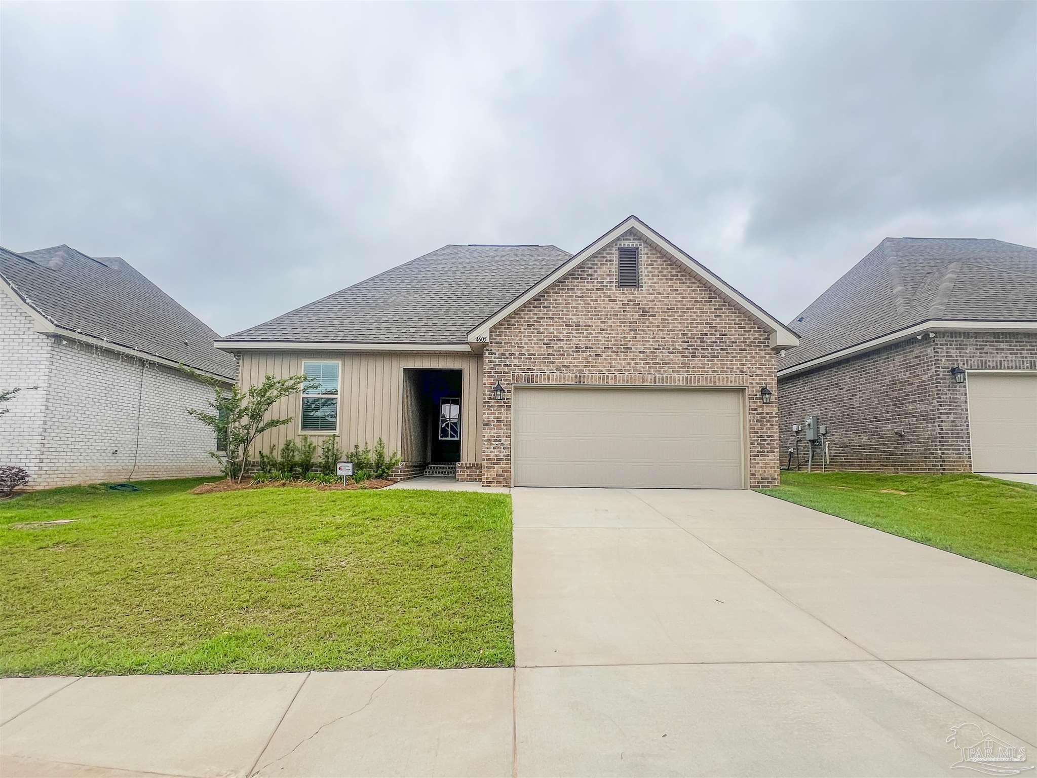 a view of a house with a yard and garage
