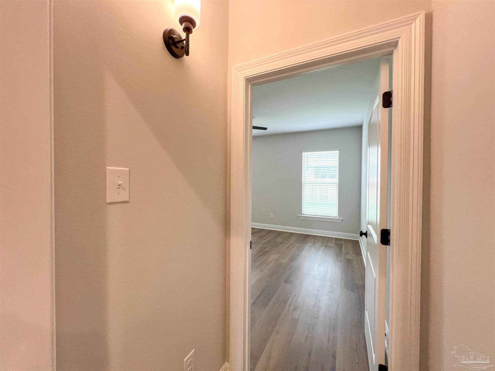4605 Sago Palm Circle Milton, FL 32571 - Photo 14 of 33 a view of a hallway with wooden floor