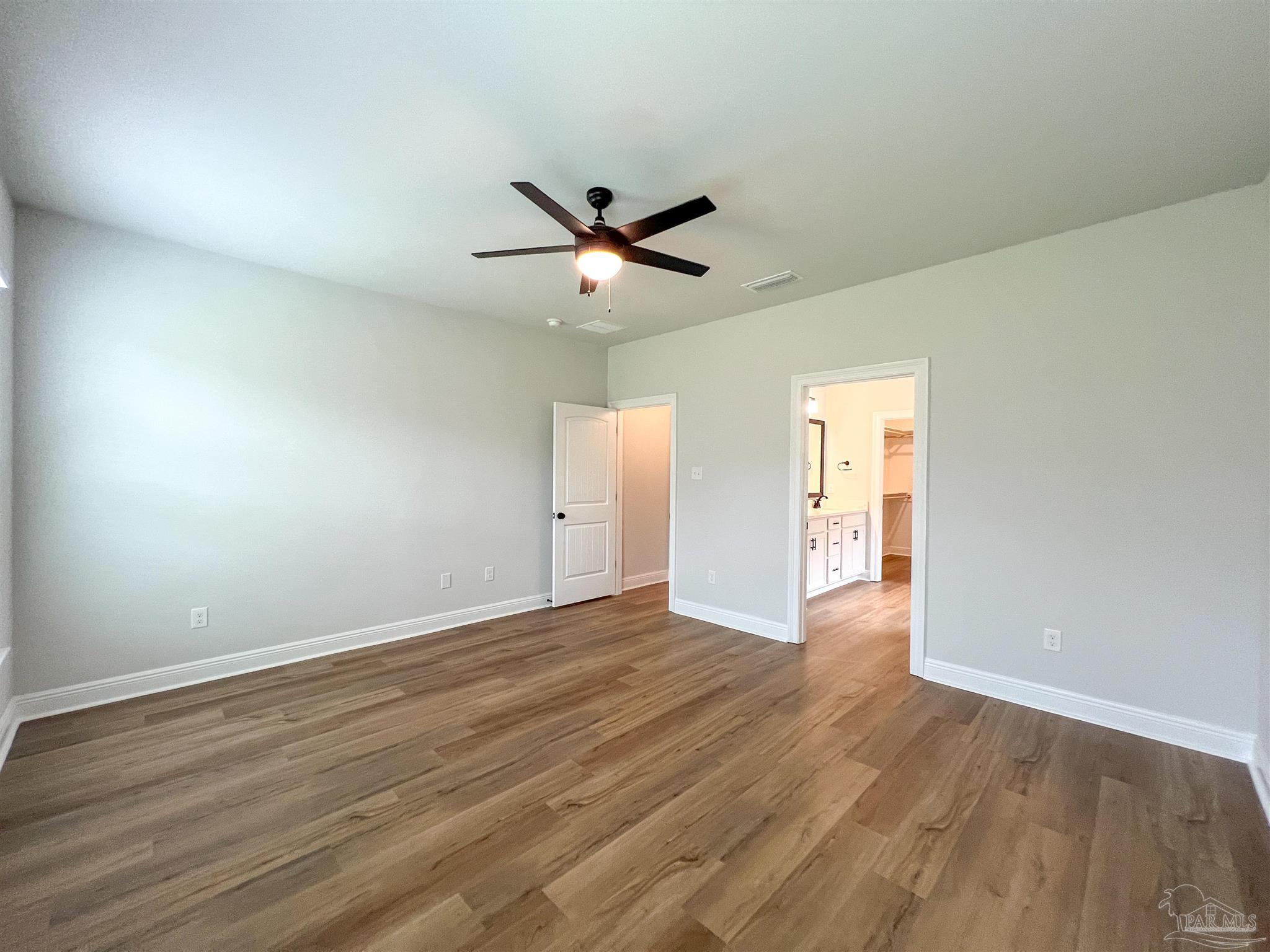 4605 Sago Palm Circle Milton, FL 32571 - Photo 16 of 33 an empty room with wooden floor and windows