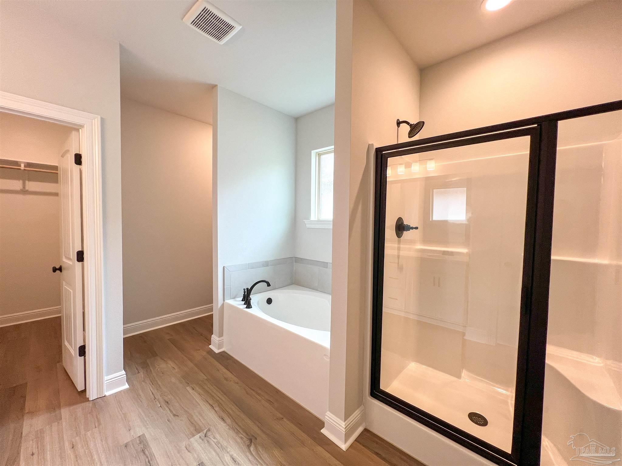 4605 Sago Palm Circle Milton, FL 32571 - Photo 18 of 33 a bathroom with a bathtub and a shower
