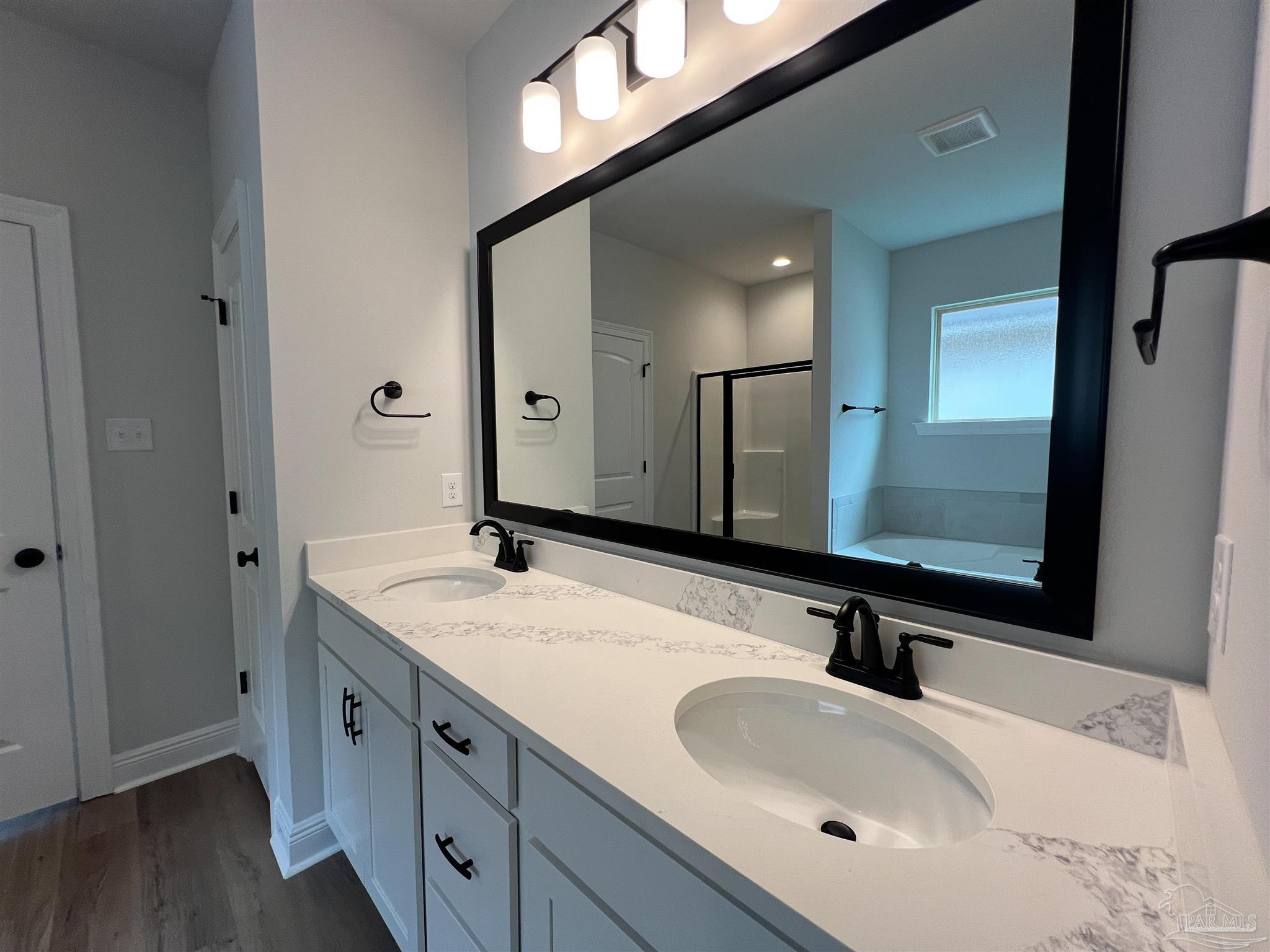 4605 Sago Palm Circle Milton, FL 32571 - Photo 21 of 33 a bathroom with a sink and a mirror