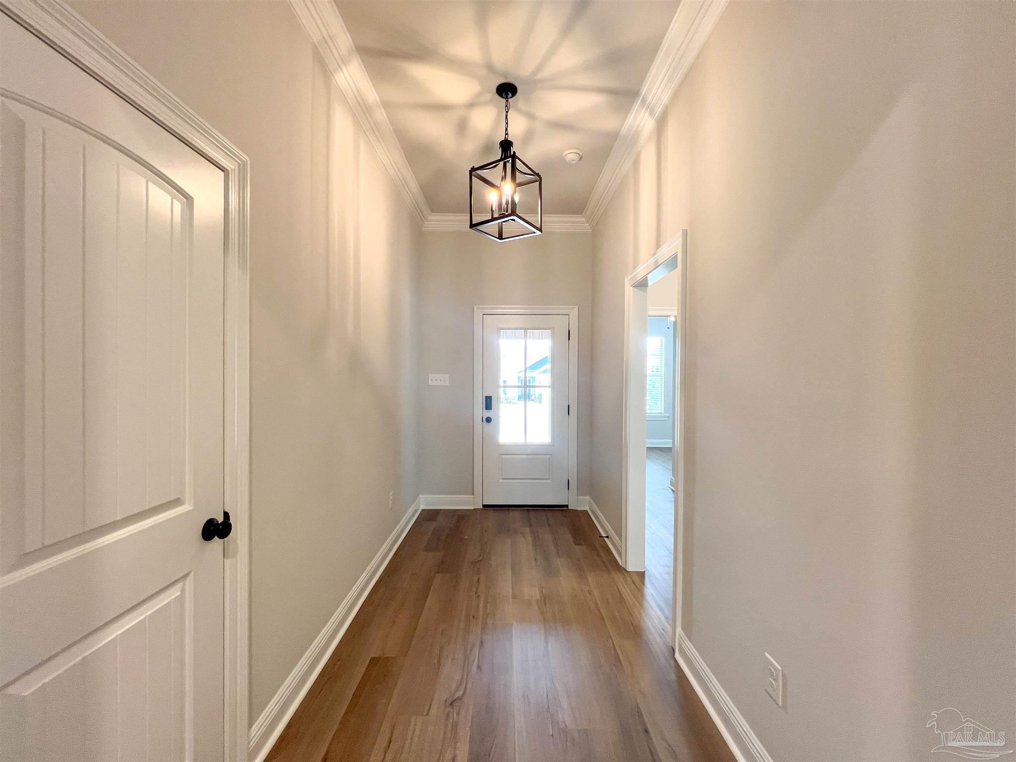 4605 Sago Palm Circle Milton, FL 32571 - Photo 22 of 33 a view of a hallway with wooden floor and staircase