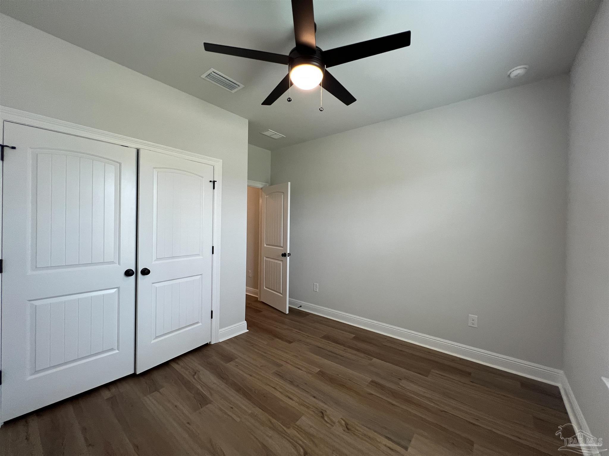 4605 Sago Palm Circle Milton, FL 32571 - Photo 25 of 33 a view of an empty room with wooden floor