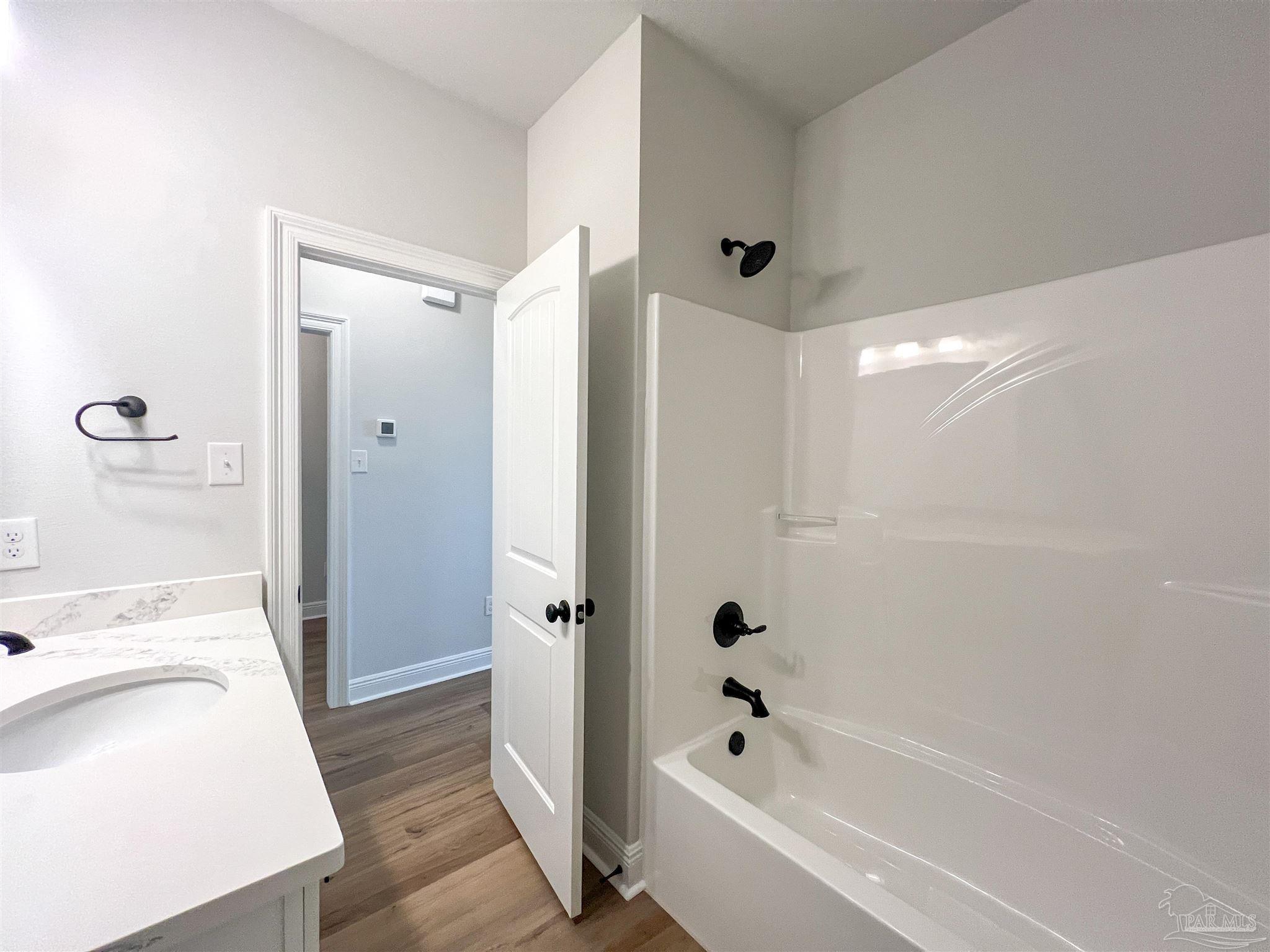 4605 Sago Palm Circle Milton, FL 32571 - Photo 27 of 33 a bathroom with a tub sink and mirror