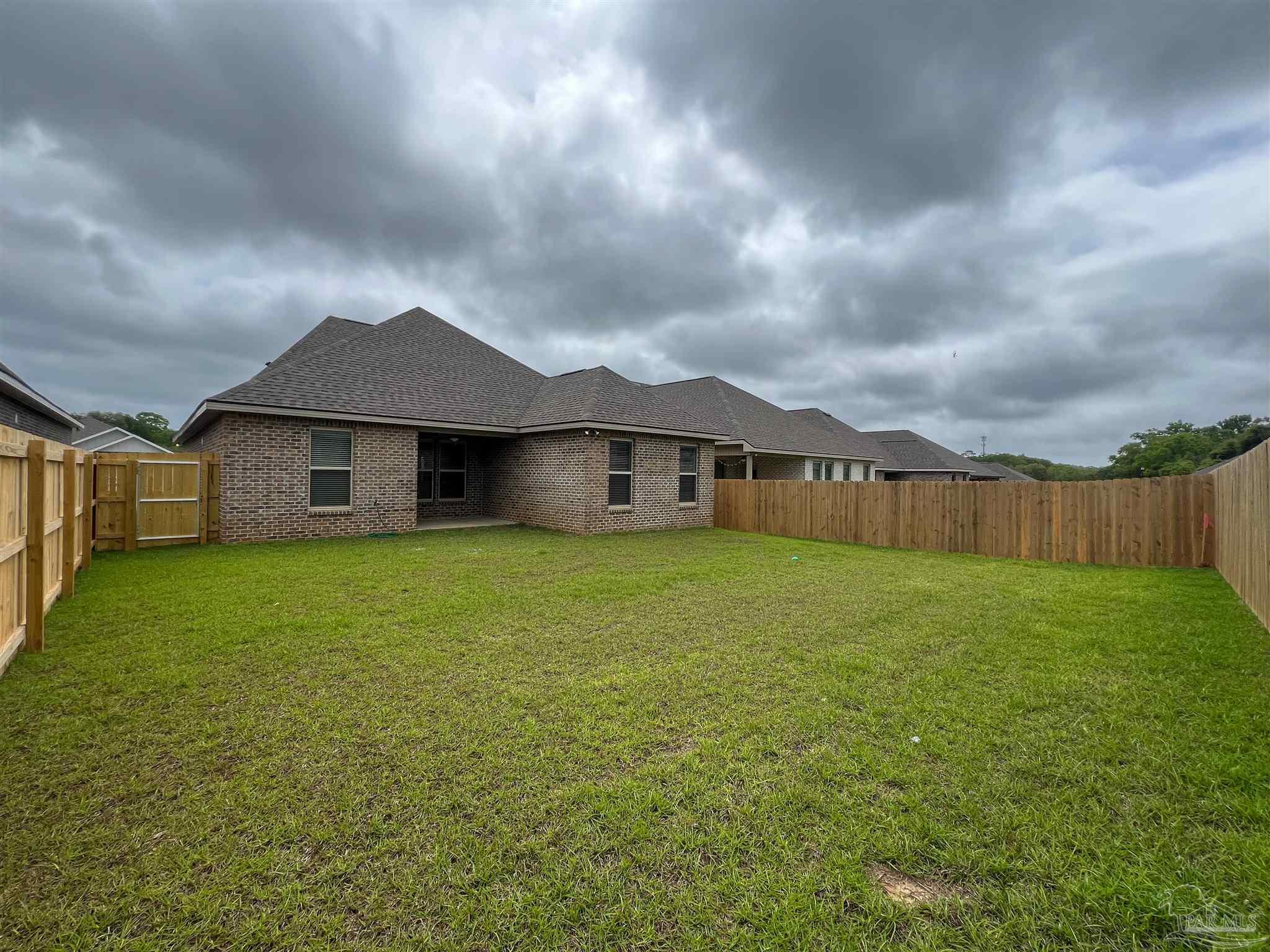 4605 Sago Palm Circle Milton, FL 32571 - Photo 33 of 33 a house view with a garden space
