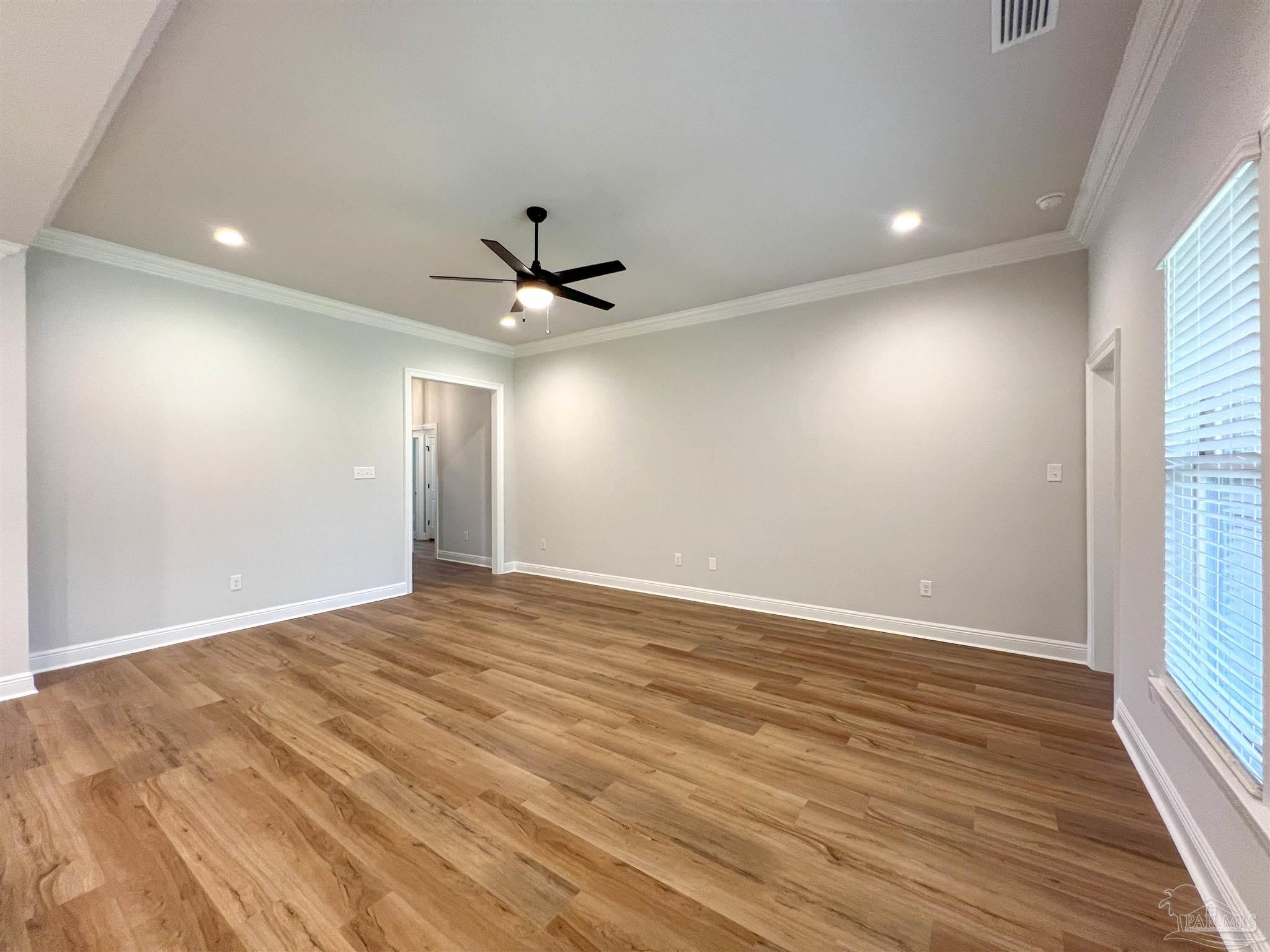 4605 Sago Palm Circle Milton, FL 32571 - Photo 4 of 33 an empty room with wooden floor and windows