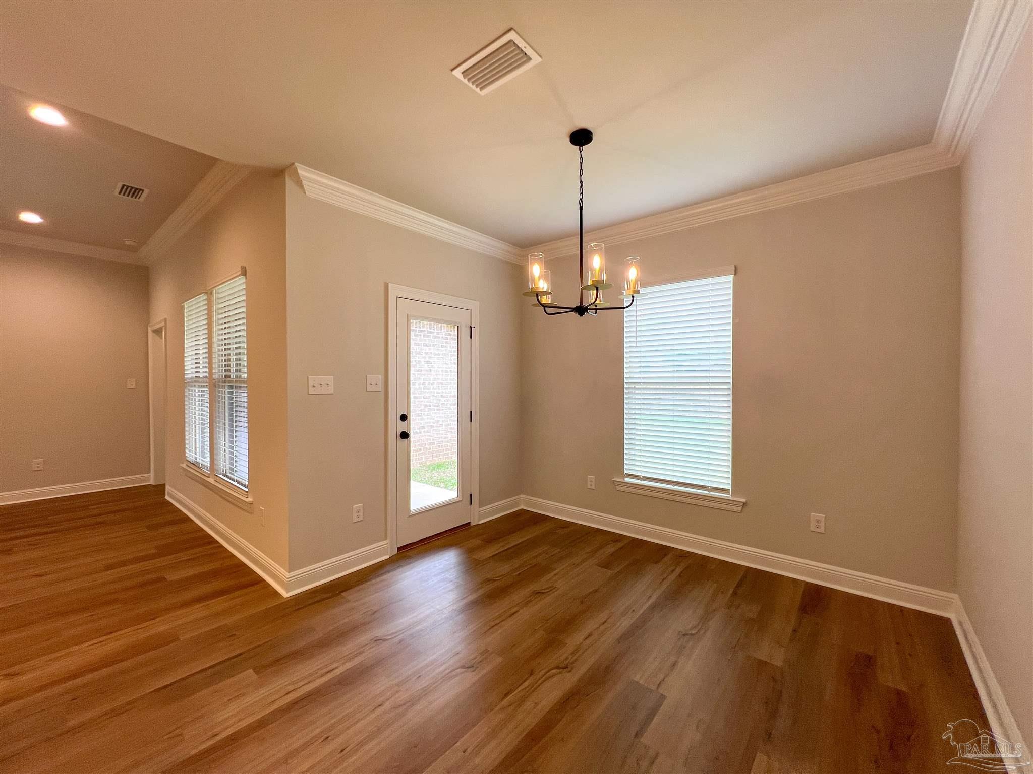 4605 Sago Palm Circle Milton, FL 32571 - Photo 8 of 33 a view of empty room with wooden floor and window