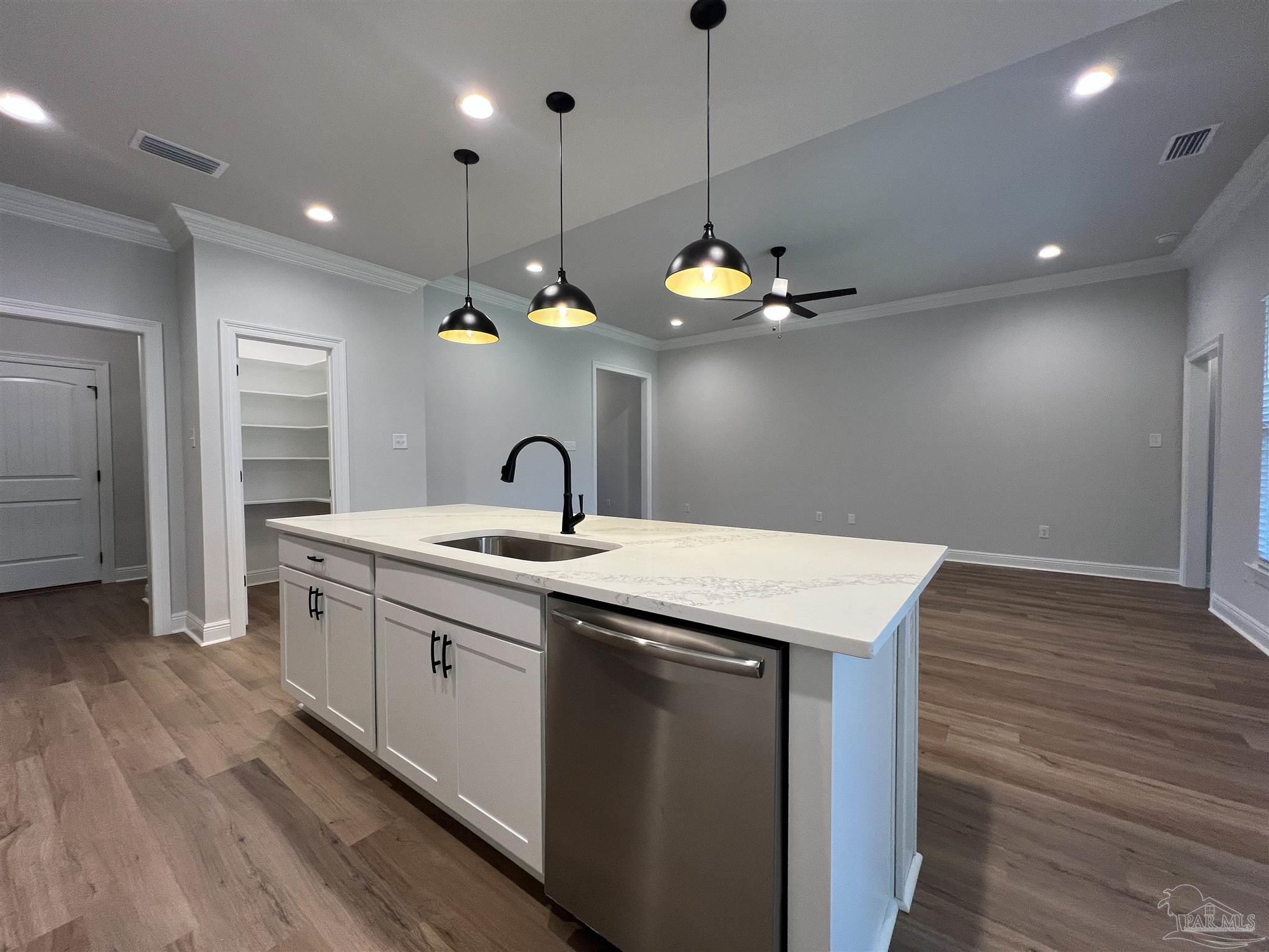 4605 Sago Palm Circle Milton, FL 32571 - Photo 9 of 33 a large kitchen with stainless steel appliances a large center island attached withe living room