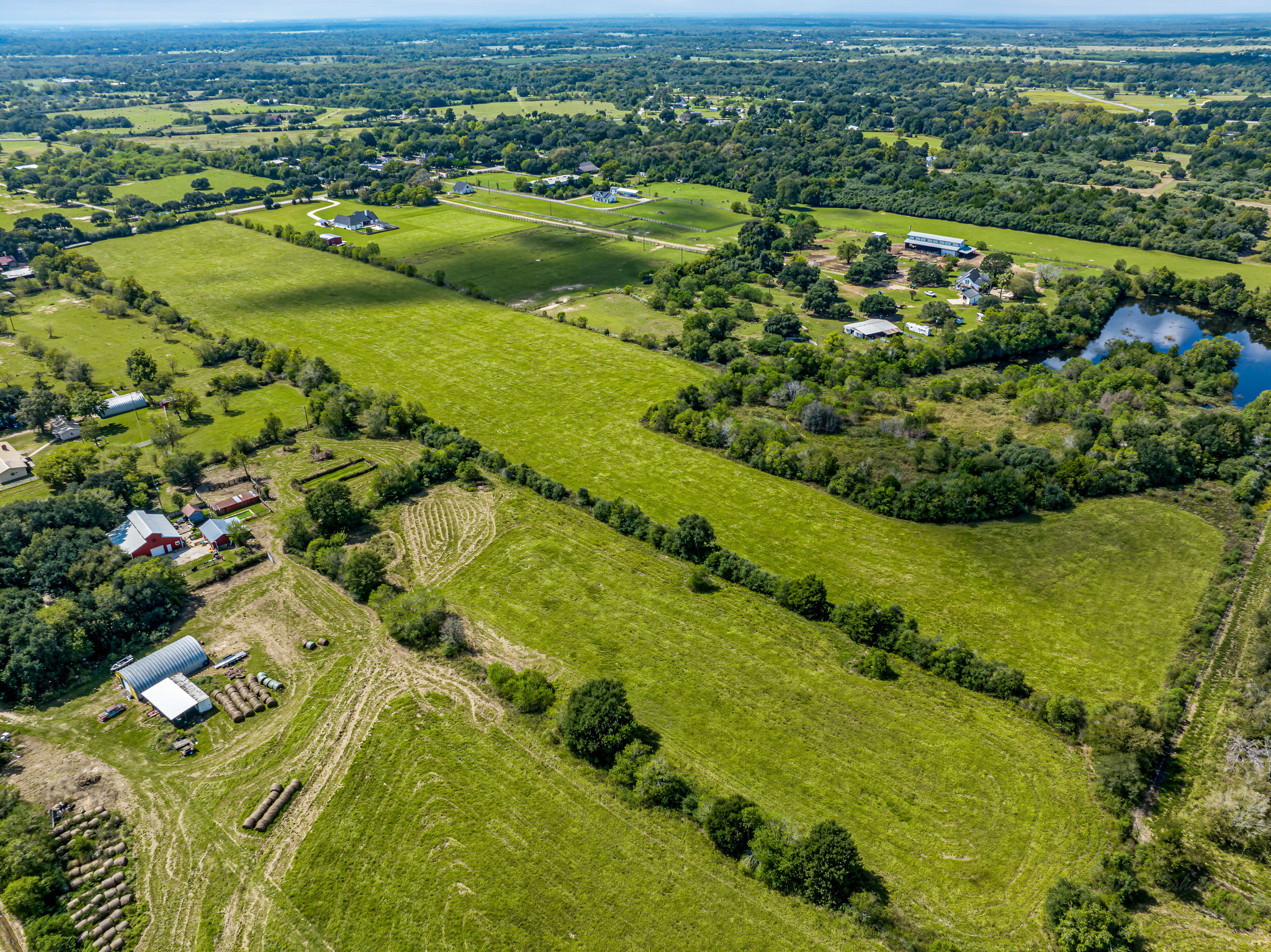 37280 Clapp Road Brookshire, TX 77423 - Photo 19 of 34 Vast green pastures and rolling rural acreage stretch toward the distant horizon.