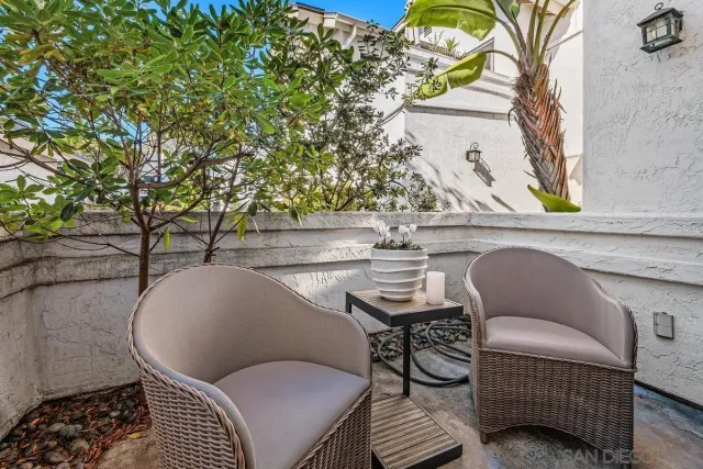 a balcony with table and chairs