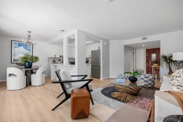 a living room with furniture and flowers