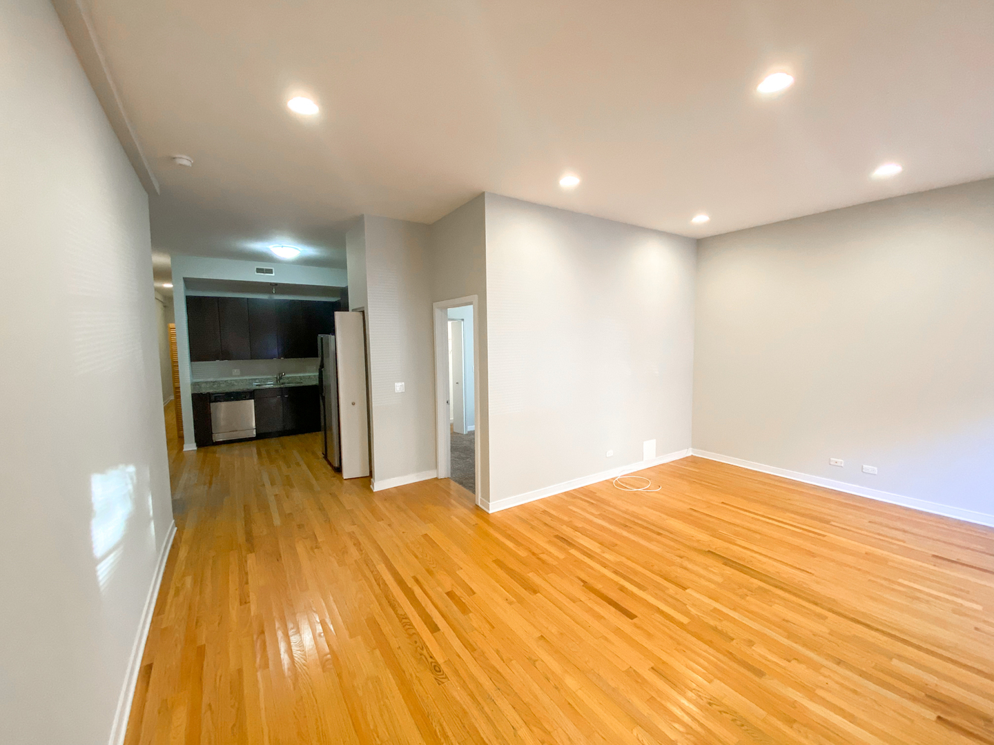 Undisclosed Address Chicago, IL 60612 - Photo 5 of 13 a view of an empty room with a kitchen