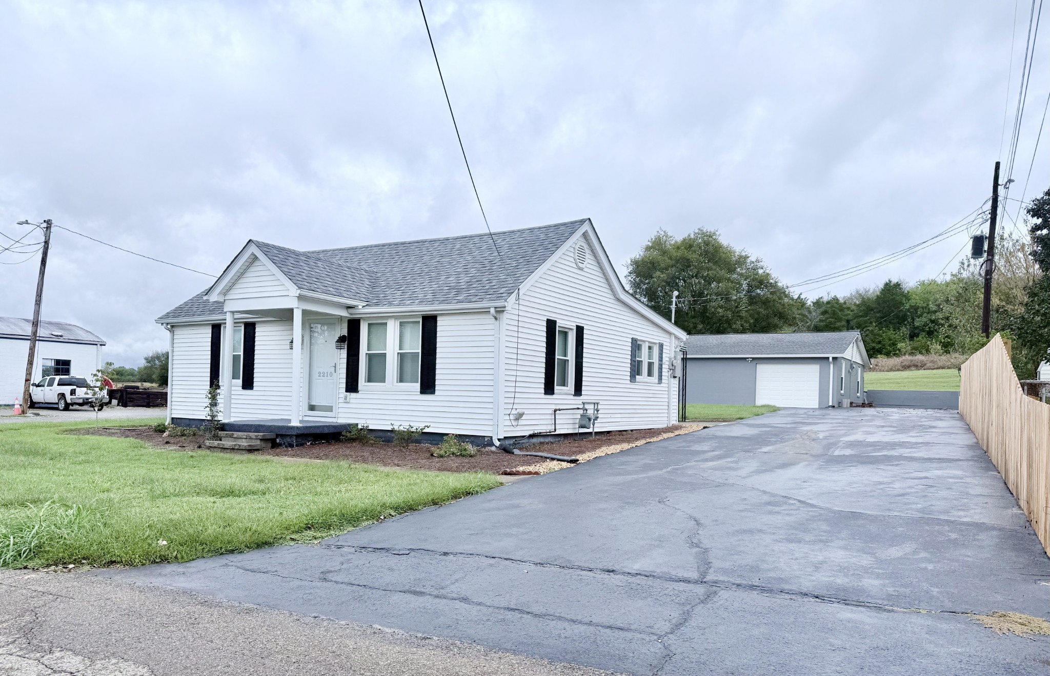 a view of a house with a yard and deck