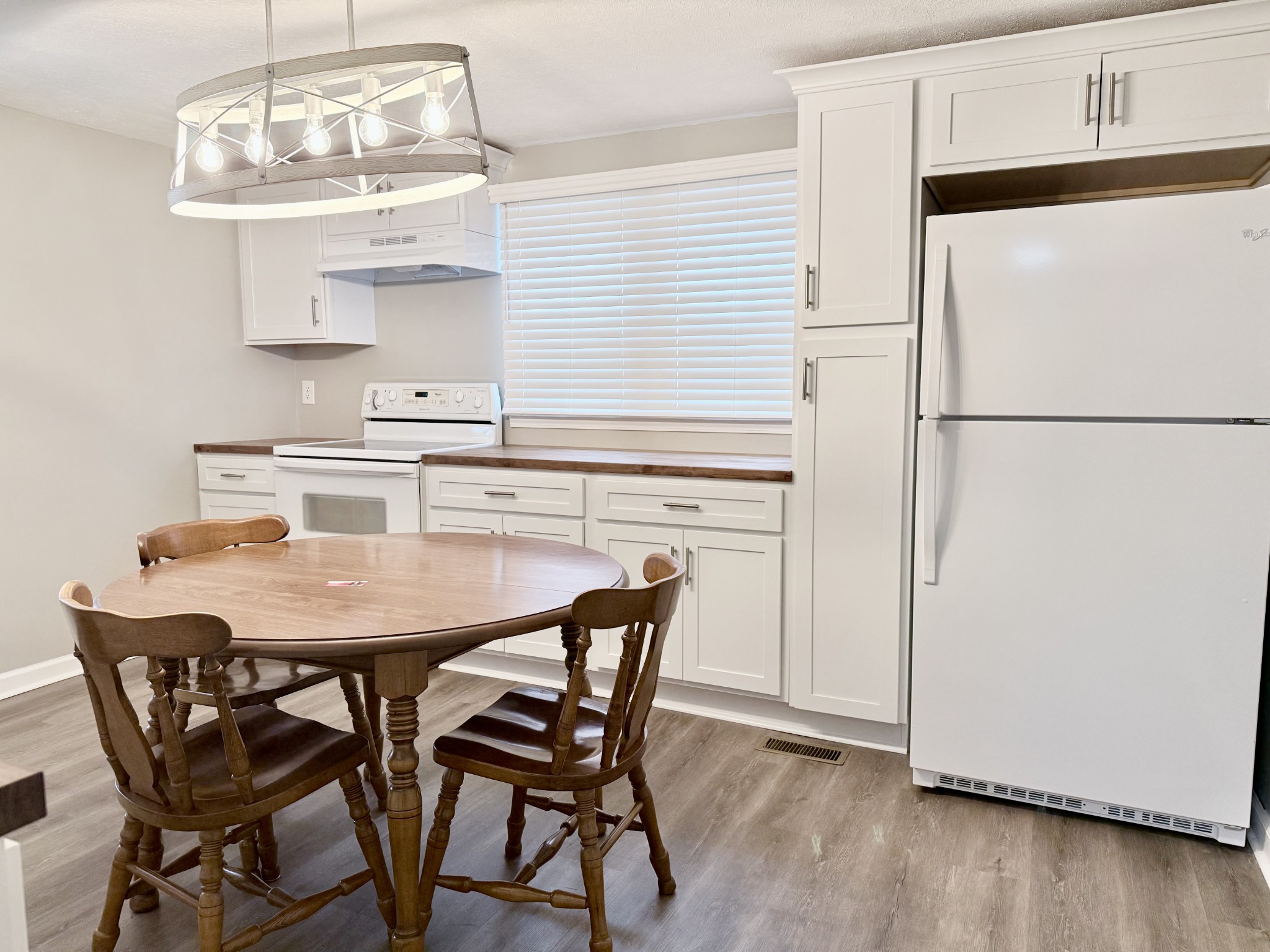 2210 Princeton Road Hopkinsville, KY 42240 - Photo 17 of 34 a kitchen with stainless steel appliances a white table chairs and a refrigerator
