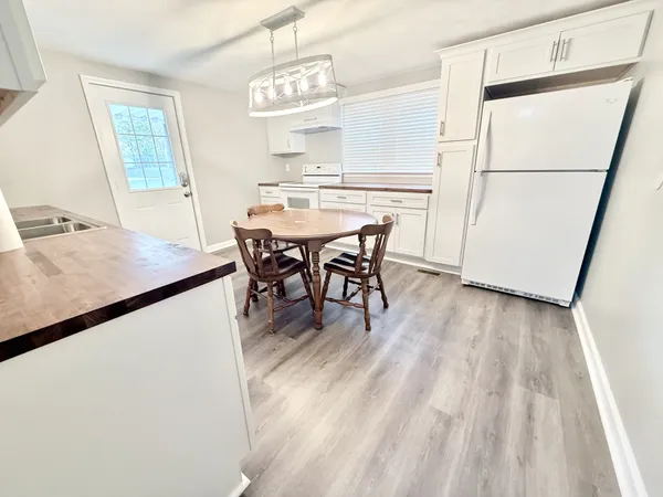 a bathroom with a granite countertop sink mirror vanity and toilet