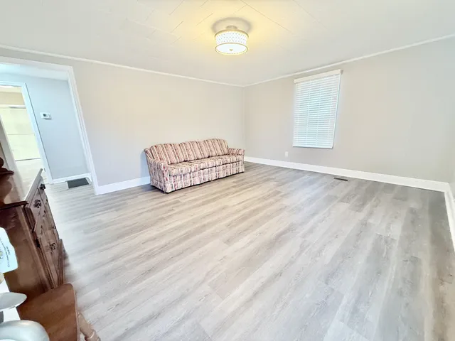 a view of a room with wooden floor and fan