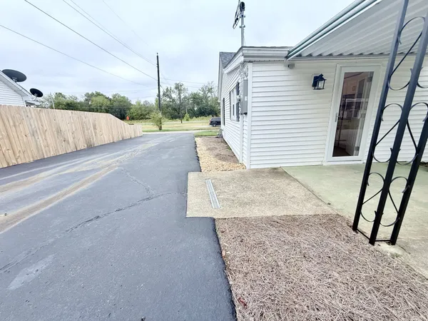 a view of a back yard with a wooden fence