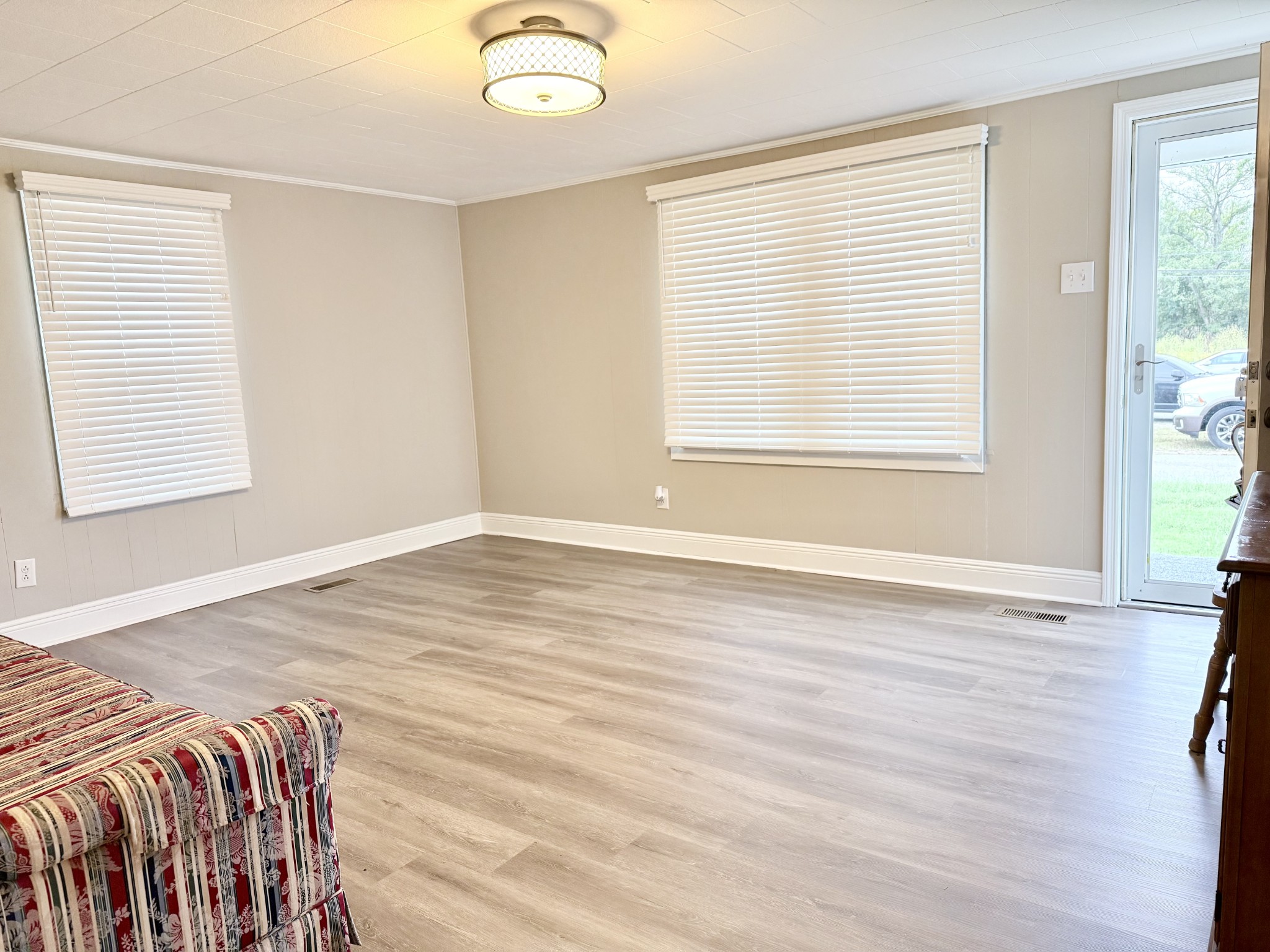 2210 Princeton Road Hopkinsville, KY 42240 - Photo 6 of 34 a view of a bedroom with wooden floor and a window