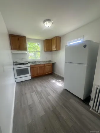 a kitchen with a refrigerator and a stove top oven