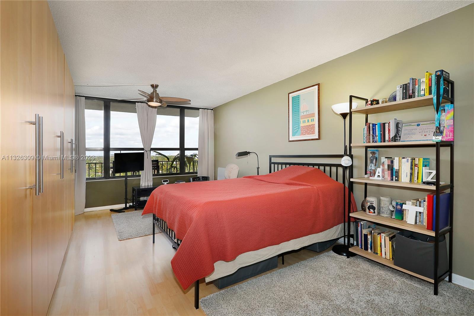 780 Northeast 69th Street, Unit 1004 Miami, FL 33138 - Photo 13 of 41 a bed room with a bed and a book shelf