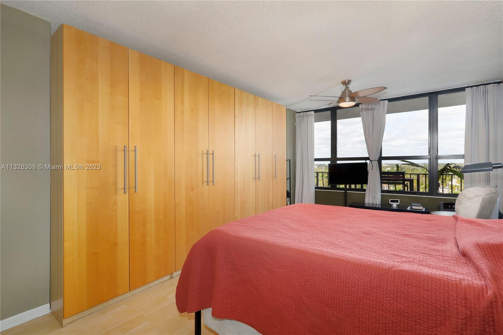 780 Northeast 69th Street, Unit 1004 Miami, FL 33138 - Photo 14 of 41 a bed sitting in a spacious bedroom next to a window
