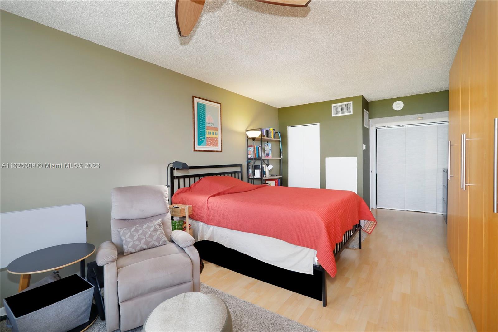 780 Northeast 69th Street, Unit 1004 Miami, FL 33138 - Photo 15 of 41 a bedroom with a bed chair and wall painting
