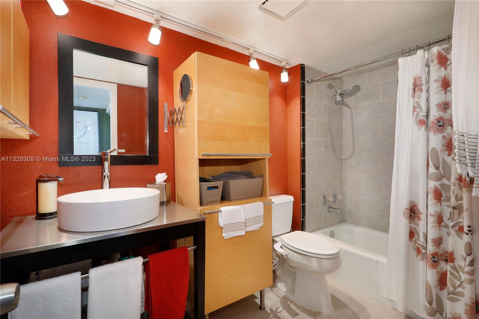 780 Northeast 69th Street, Unit 1004 Miami, FL 33138 - Photo 16 of 41 a bathroom with a sink a toilet a mirror and shower
