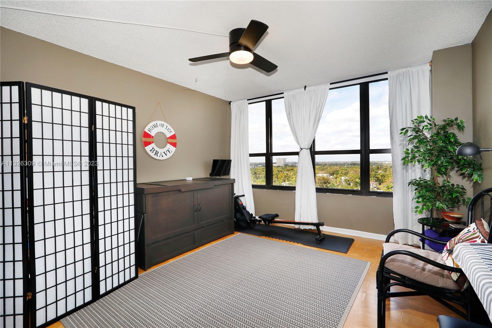 780 Northeast 69th Street, Unit 1004 Miami, FL 33138 - Photo 17 of 41 a bedroom with furniture and a window
