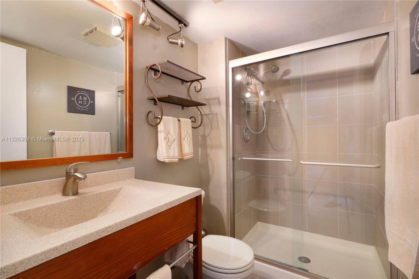 780 Northeast 69th Street, Unit 1004 Miami, FL 33138 - Photo 19 of 41 a bathroom with a sink toilet and shower