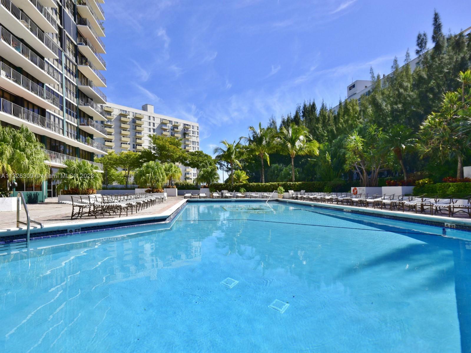 780 Northeast 69th Street, Unit 1004 Miami, FL 33138 - Photo 25 of 41 a view of a swimming pool and lounge chairs