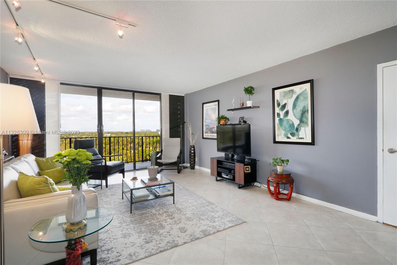 780 Northeast 69th Street, Unit 1004 Miami, FL 33138 - Photo 3 of 41 a living room with furniture and a flat screen tv