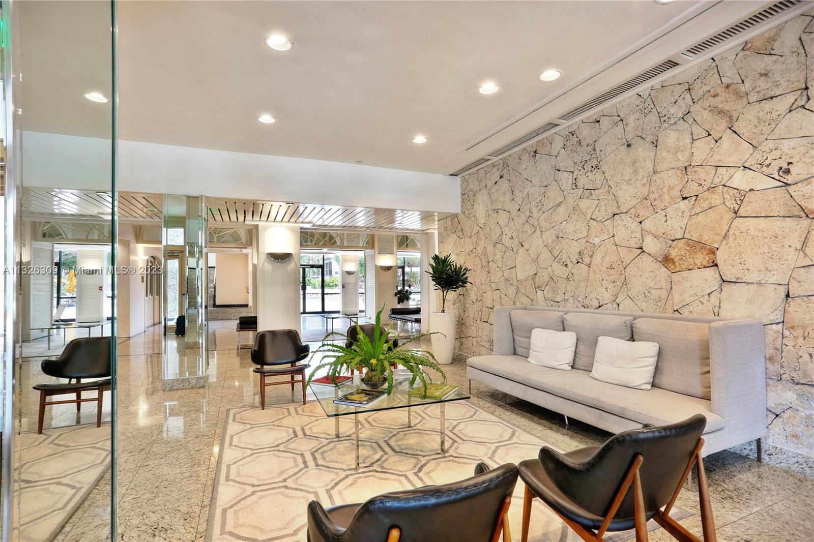 780 Northeast 69th Street, Unit 1004 Miami, FL 33138 - Photo 40 of 41 a living room with furniture and a chandelier