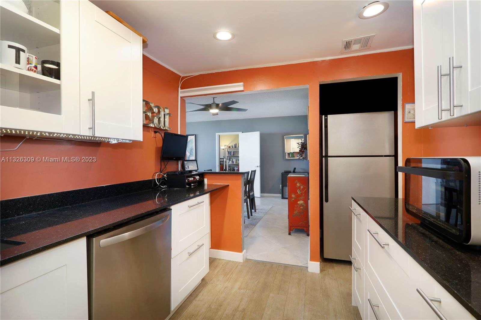 780 Northeast 69th Street, Unit 1004 Miami, FL 33138 - Photo 8 of 41 a kitchen with stainless steel appliances a refrigerator and a stove