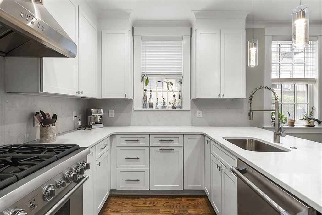 119 Highland Avenue, Unit B Somerville, MA 02143 - Photo 1 of 24 a kitchen with white cabinets and appliances
