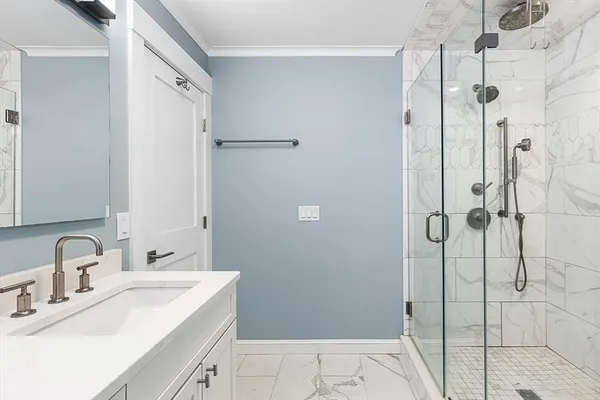 a bathroom with a sink and shower